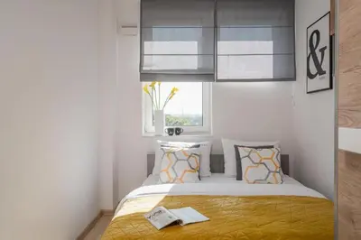 Łóżko lub łóżka w pokoju w obiekcie StarterApart Wrocław