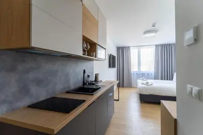 Łóżko lub łóżka w pokoju w obiekcie Milo Aparthotel