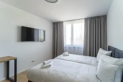 Łóżko lub łóżka w pokoju w obiekcie Milo Aparthotel