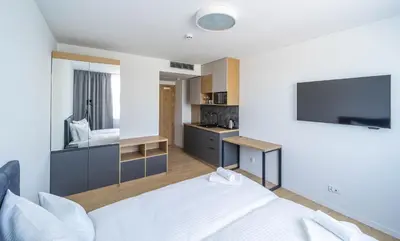 Łóżko lub łóżka w pokoju w obiekcie Milo Aparthotel