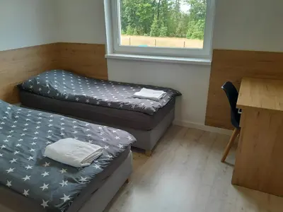 Łóżko lub łóżka w pokoju w obiekcie Apartamenty pod Jagodną