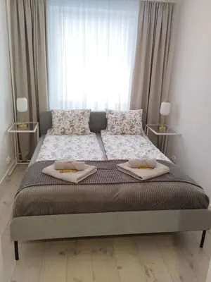 Łóżko lub łóżka w pokoju w obiekcie Moon Apartment