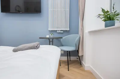 Łóżko lub łóżka w pokoju w obiekcie Apartament Berbeckiego