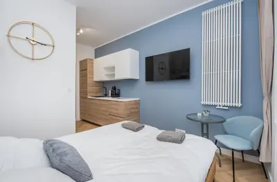 Łóżko lub łóżka w pokoju w obiekcie Apartament Berbeckiego