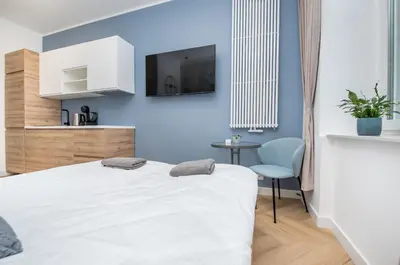 Łóżko lub łóżka w pokoju w obiekcie Apartament Berbeckiego