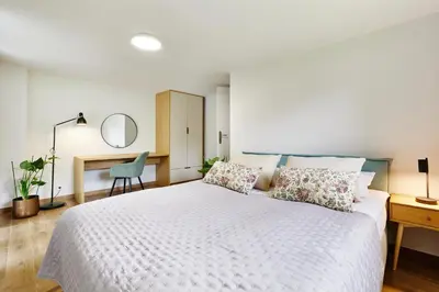 Łóżko lub łóżka w pokoju w obiekcie Resort Zacisze Apartamenty