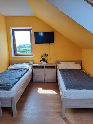 Łóżko lub łóżka w pokoju w obiekcie Ogrodowe Noclegi