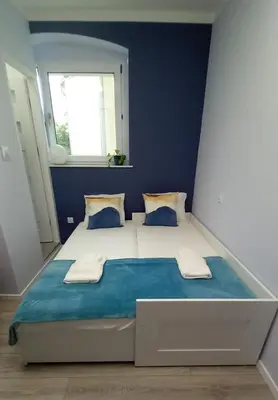 Łóżko lub łóżka w pokoju w obiekcie Apartment Błękitny
