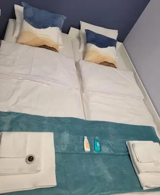Łóżko lub łóżka w pokoju w obiekcie Apartment Błękitny