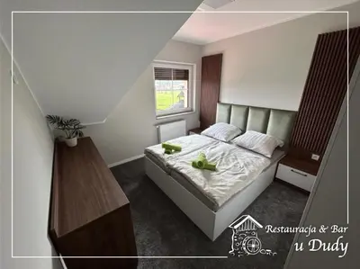 Łóżko lub łóżka w pokoju w obiekcie Restauracja & Bar u Dudy