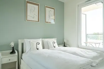 Łóżko lub łóżka w pokoju w obiekcie RentPlanet - Apartamenty Zajezdnia