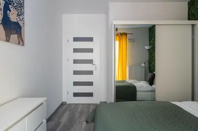 Łóżko lub łóżka w pokoju w obiekcie RentPlanet - Apartamenty Księcia Witolda