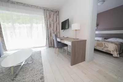 Łóżko lub łóżka w pokoju w obiekcie VacationClub - Bormio Apartament 13