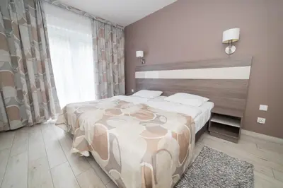 Łóżko lub łóżka w pokoju w obiekcie VacationClub - Bormio Apartament 13