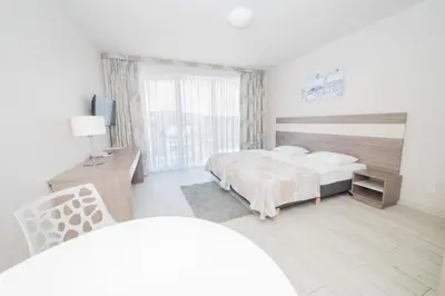 Łóżko lub łóżka w pokoju w obiekcie VacationClub - Bormio Apartament 8