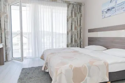 Łóżko lub łóżka w pokoju w obiekcie VacationClub - Bormio Apartament 8