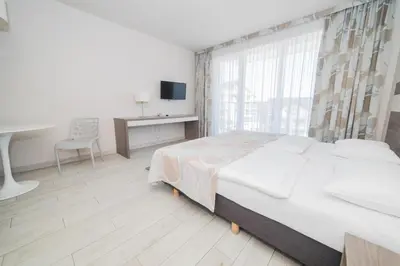 Łóżko lub łóżka w pokoju w obiekcie VacationClub - Bormio Apartament 8