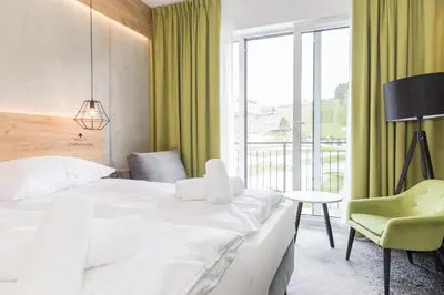 Łóżko lub łóżka w pokoju w obiekcie VacationClub - Czarna Perła Apartament 303