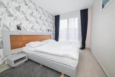 Łóżko lub łóżka w pokoju w obiekcie VacationClub - Stubai Apartament 11