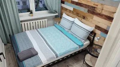 Łóżko lub łóżka w pokoju w obiekcie APARTAMENT 