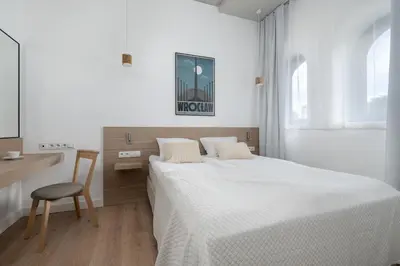 Łóżko lub łóżka w pokoju w obiekcie PIEKARNIA Żywa Kultura Atmospheric Apartments in Wrocław by Noclegi Renters