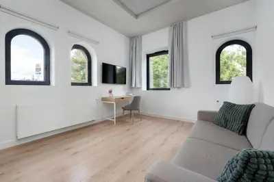 Telewizja i/lub zestaw kina domowego w obiekcie PIEKARNIA Żywa Kultura Atmospheric Apartments in Wrocław by Noclegi Renters