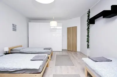 Łóżko lub łóżka w pokoju w obiekcie Apartament Piwna 13