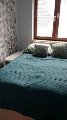 Łóżko lub łóżka w pokoju w obiekcie Apartament Zalesie z tarasem