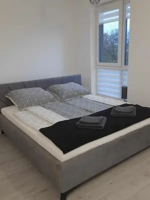 Łóżko lub łóżka w pokoju w obiekcie APARTAMENT OLIWIER