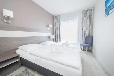 Łóżko lub łóżka w pokoju w obiekcie VacationClub - Bormio Apartament 5