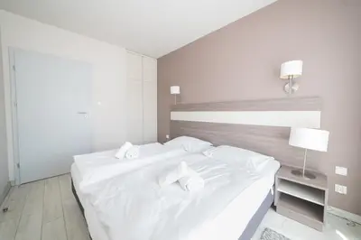 Łóżko lub łóżka w pokoju w obiekcie VacationClub - Bormio Apartament 5