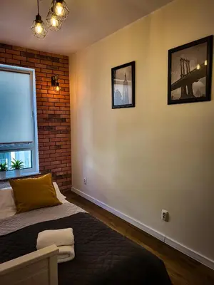 Łóżko lub łóżka w pokoju w obiekcie Apartament Ceglany