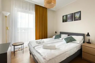 Łóżko lub łóżka w pokoju w obiekcie Apartament Miodowy - Penthouse z balkonem