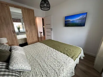 Łóżko lub łóżka w pokoju w obiekcie Apartament 28 w Dolinie Baryczy - 5D Apartamenty