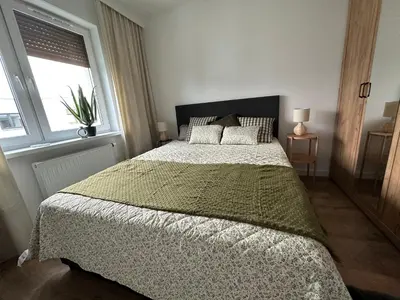 Łóżko lub łóżka w pokoju w obiekcie Apartament 28 w Dolinie Baryczy - 5D Apartamenty