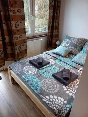 Łóżko lub łóżka w pokoju w obiekcie Przytulny Apartament z Balkonem