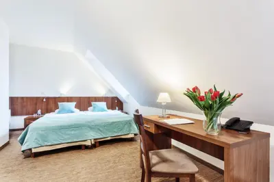 Łóżko lub łóżka w pokoju w obiekcie Hotel Modrzewiowy Dwór
