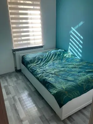Łóżko lub łóżka w pokoju w obiekcie Apartament Centrum