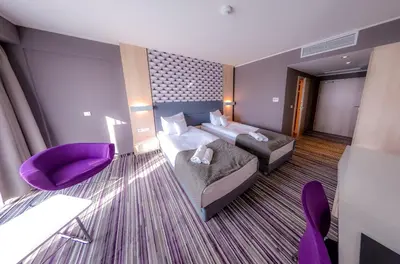 Łóżko lub łóżka w pokoju w obiekcie Hotel Astone Conference & Spa