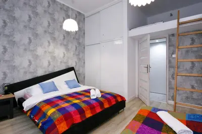Łóżko lub łóżka w pokoju w obiekcie Apartament przy Palmiarni