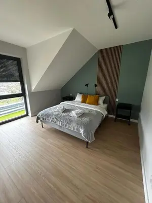 Łóżko lub łóżka w pokoju w obiekcie Apartamenty Parkowa - Kamień Śląski