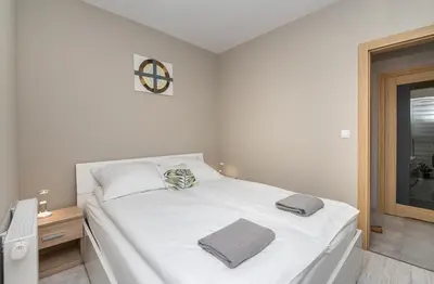 Łóżko lub łóżka w pokoju w obiekcie Apartament Biegusa