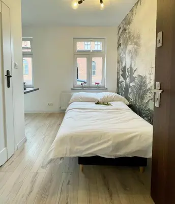 Łóżko lub łóżka w pokoju w obiekcie Studio Bielawa u podnóża Gór Sowich