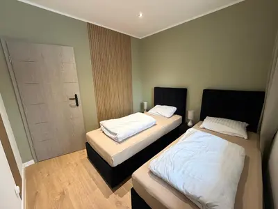 Łóżko lub łóżka w pokoju w obiekcie Duży Apartament 3 pokoje Park City