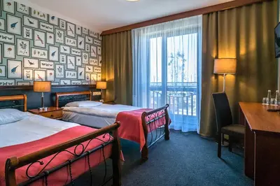 Łóżko lub łóżka w pokoju w obiekcie Resort Strzelnica