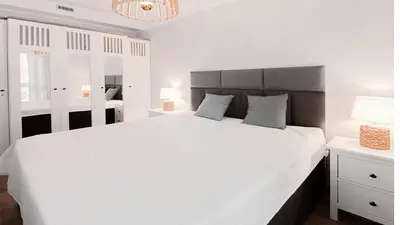 Łóżko lub łóżka w pokoju w obiekcie VacationClub - Aleja Zwycięzców Apartament 12