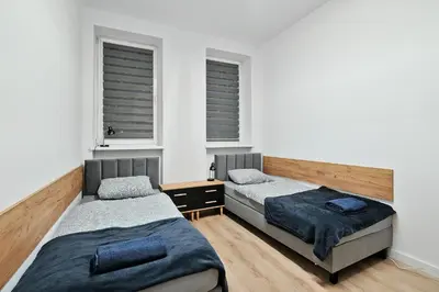 Łóżko lub łóżka w pokoju w obiekcie Tanie Spanie