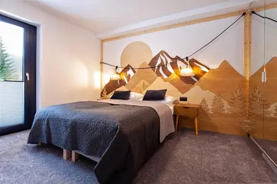 Łóżko lub łóżka w pokoju w obiekcie APARTAMENTY FAMILY SKI&BIKE HOUSE