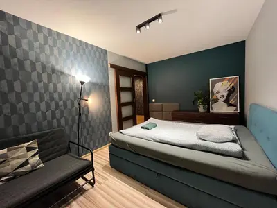 Łóżko lub łóżka w pokoju w obiekcie Family House Pomorska 32 Centrum Tectum Apartments