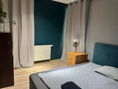 Łóżko lub łóżka w pokoju w obiekcie Family House Pomorska 32 Centrum Tectum Apartments